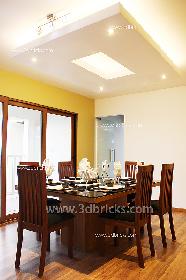 Wooden Flooring underfoot and a yellow wall enhance the dinning area