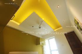 Yellow ceiling harmoniously in tune with the green walls